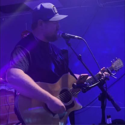 Scotty Sams performing live with guitar