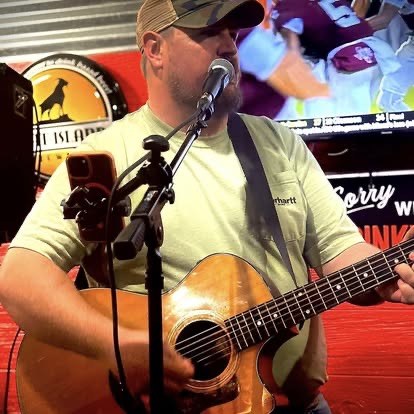 Scotty Sams singing into microphone